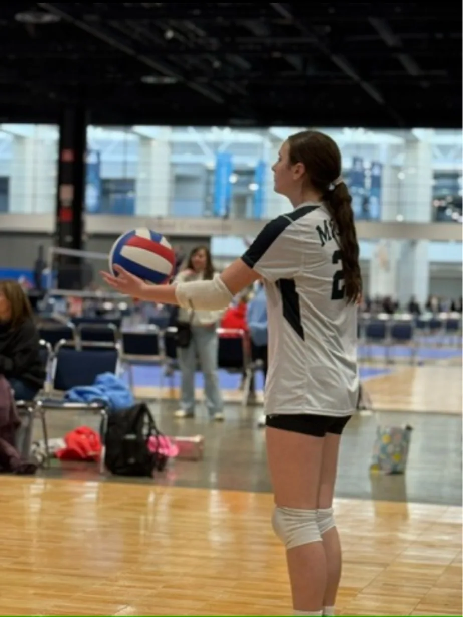 Adrianna preparing to serve at a tournament